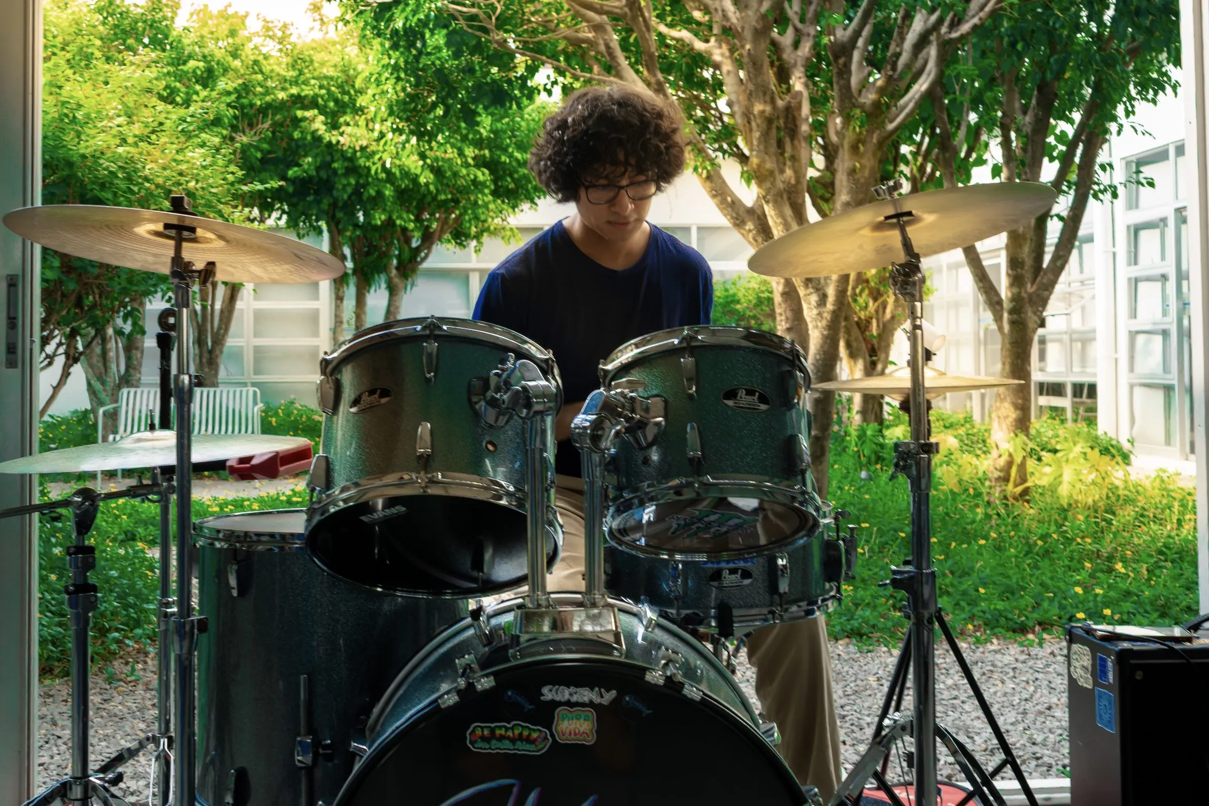Playing drums outdoors, seen from in front of the kit